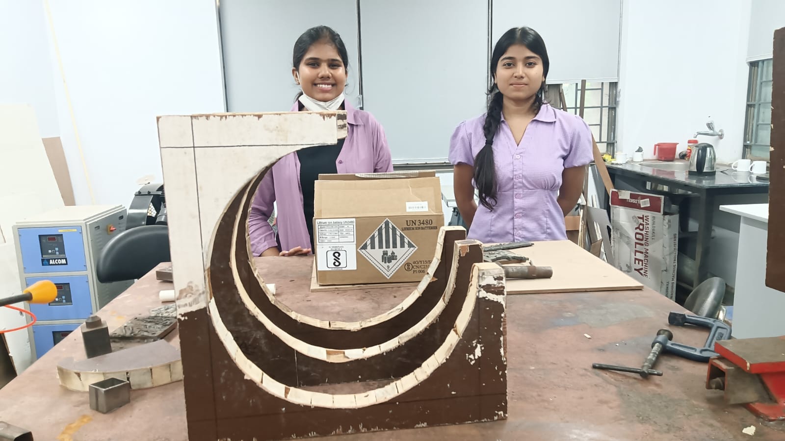 A wooden table designed by design students for use with a hand router