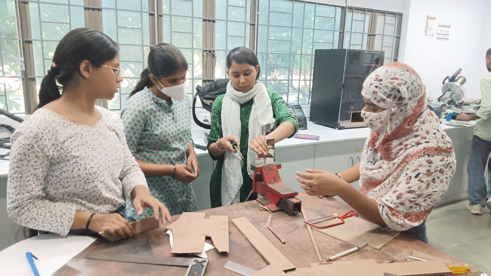 A wooden table designed by design students for use with a hand router