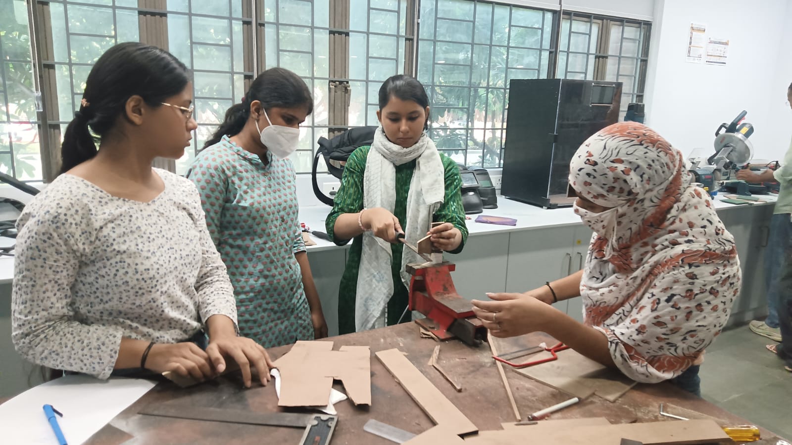 A wooden table designed by design students for use with a hand router